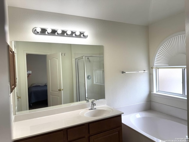 8002 Wever Xing, San Antonio, TX 78250 - bathroom featuring connected bathroom, a bath, vanity, a shower stall, and a textured wall