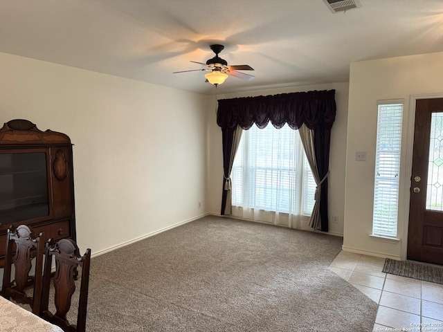 8002 Wever Xing, San Antonio, TX 78250 - entrance foyer with healthy amount of natural light, light carpet, ceiling fan, and light tile patterned floors