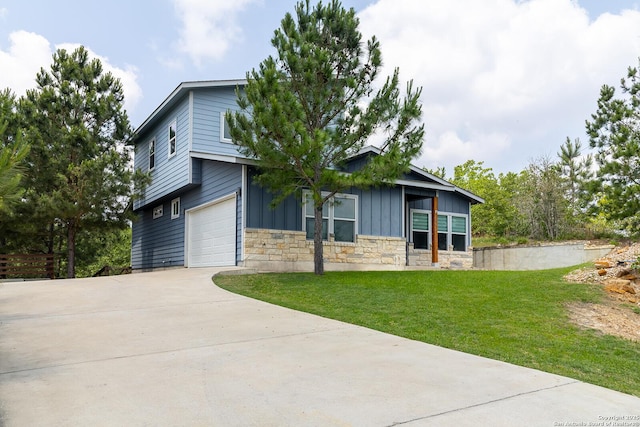 104 Kahalulu, Bastrop, TX 78602 - view of front of property featuring board and batten siding, stone siding, concrete driveway, a front lawn, and an attached garage