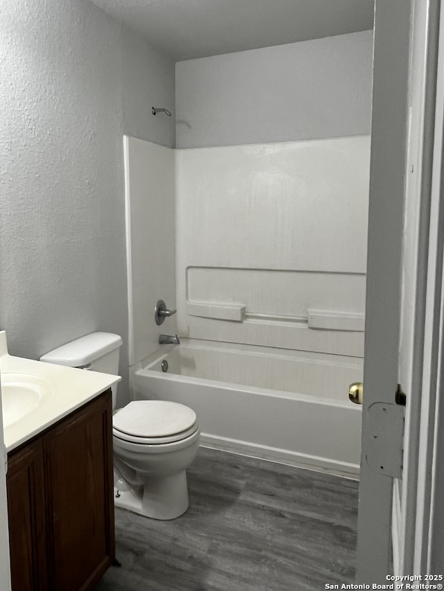 8619 Key N, Converse, TX 78109 - full bathroom with vanity, toilet, a textured wall, tub / shower combination, and wood finished floors