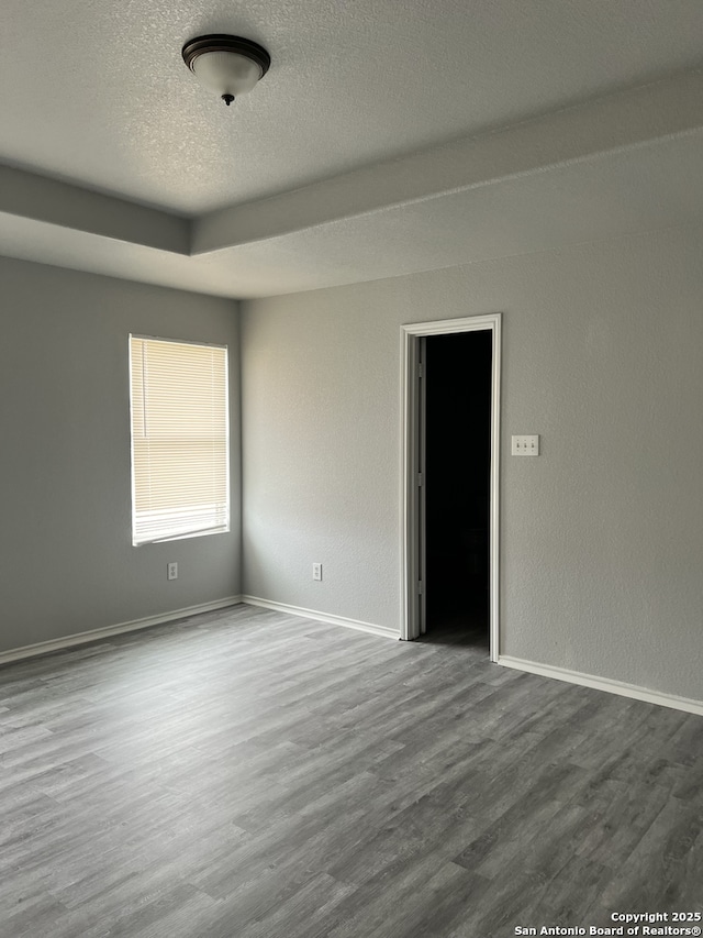 8619 Key N, Converse, TX 78109 - empty room with wood finished floors, baseboards, and a textured ceiling