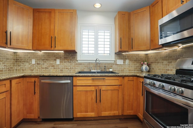 2834 Burning Log, San Antonio, TX 78247 - kitchen featuring stainless steel appliances, a sink, backsplash, light stone countertops, and recessed lighting