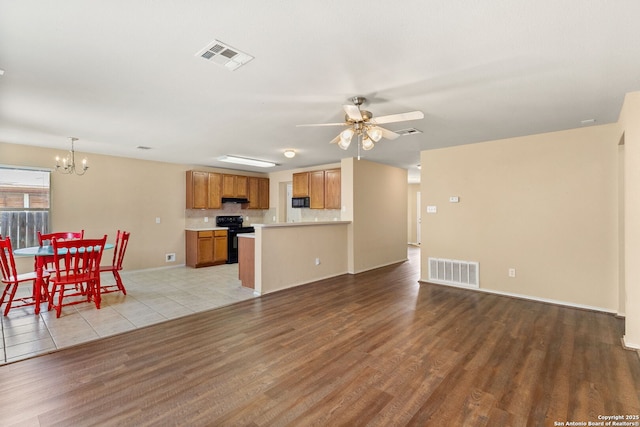3628 Tilden, New Braunfels, TX 78132 - living room with light wood-type flooring, a chandelier, a ceiling fan, and baseboards