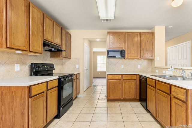 3628 Tilden, New Braunfels, TX 78132 - kitchen with black appliances, under cabinet range hood, a sink, and light countertops