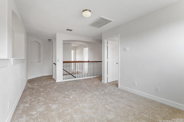 5801 Devonwood, Cibolo, TX 78108 - spare room featuring carpet floors, arched walkways, and baseboards