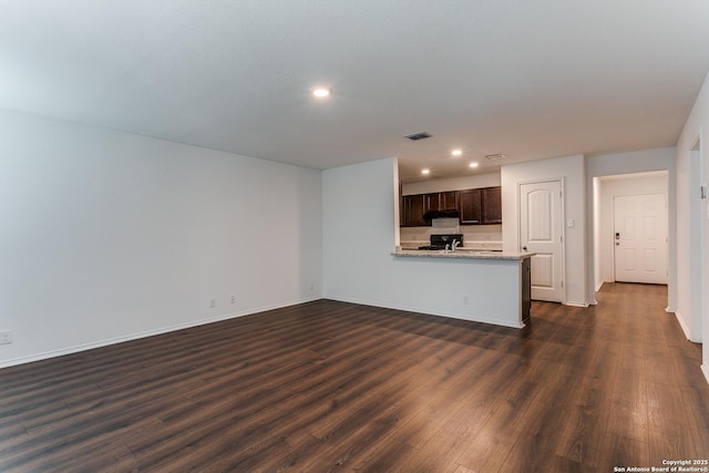 5518 Salado Fls, San Antonio, TX 78222 - unfurnished living room with recessed lighting, dark wood finished floors, and baseboards