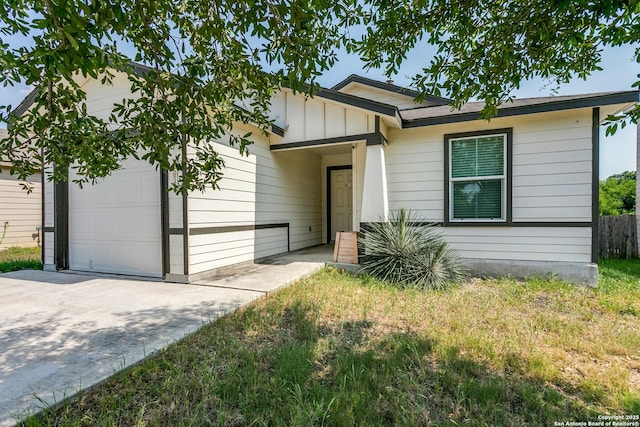 5518 Salado Fls, San Antonio, TX 78222 - ranch-style home featuring an attached garage, concrete driveway, and board and batten siding