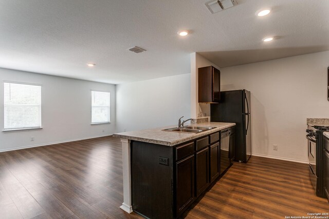 5518 Salado Fls, San Antonio, TX 78222 - kitchen featuring a sink, black appliances, open floor plan, dark wood-type flooring, and recessed lighting