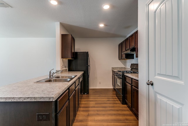 5518 Salado Fls, San Antonio, TX 78222 - kitchen with black gas range oven, a sink, dark brown cabinets, dark wood-type flooring, and light countertops