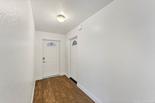 11219 Five Iron, San Antonio, TX 78221 - entryway featuring dark wood-style flooring, baseboards, and a textured ceiling