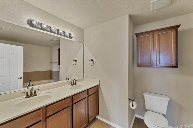11219 Five Iron, San Antonio, TX 78221 - full bathroom featuring toilet, double vanity, a bath, tile patterned floors, and a textured ceiling