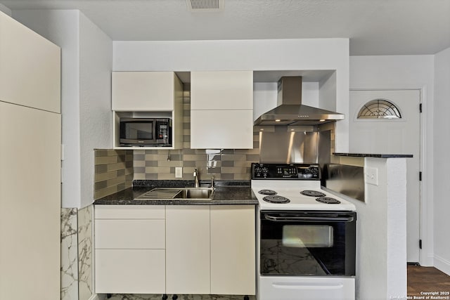 11219 Five Iron, San Antonio, TX 78221 - kitchen with range with electric cooktop, wall chimney range hood, a sink, white cabinetry, and backsplash