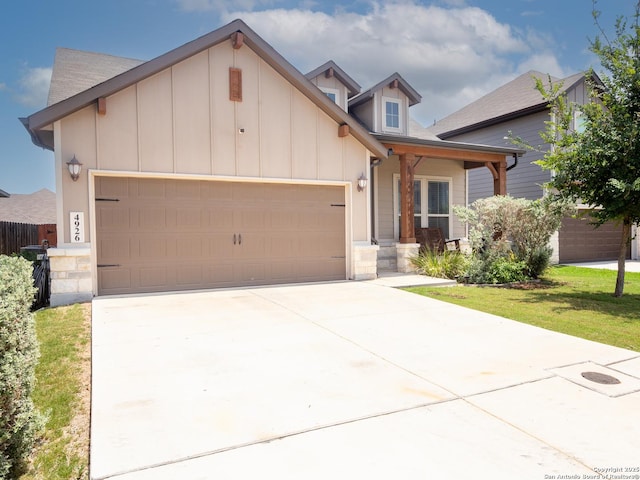 4926 Drifter Oaks, Saint Hedwig, TX 78152 - view of front facade featuring board and batten siding, an attached garage, driveway, and stone siding