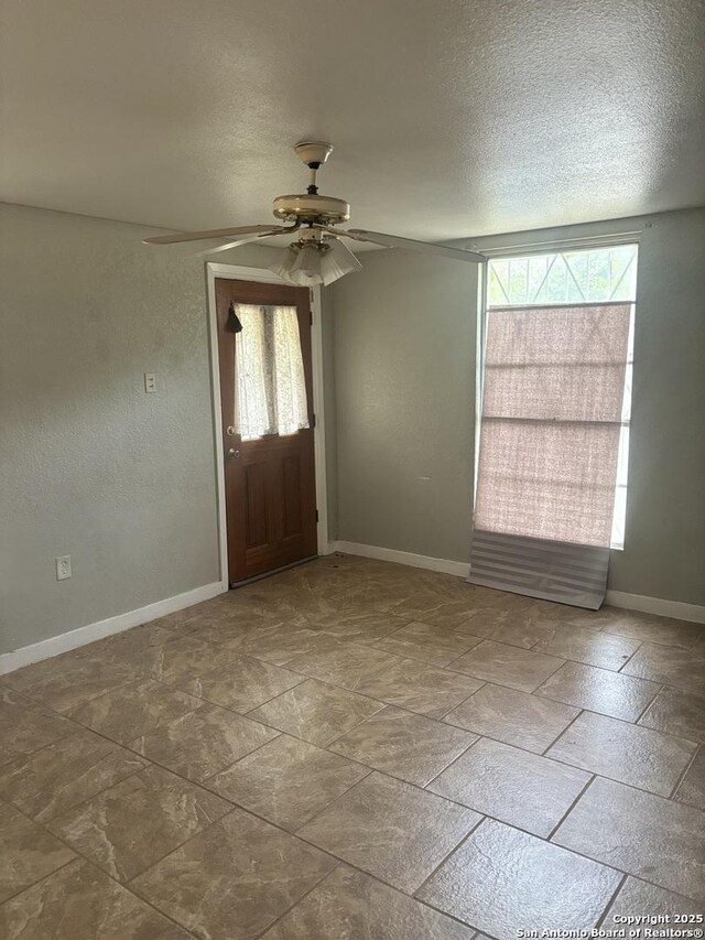 1238 Kendalia, San Antonio, TX 78224 - entryway featuring a ceiling fan, a textured ceiling, and baseboards