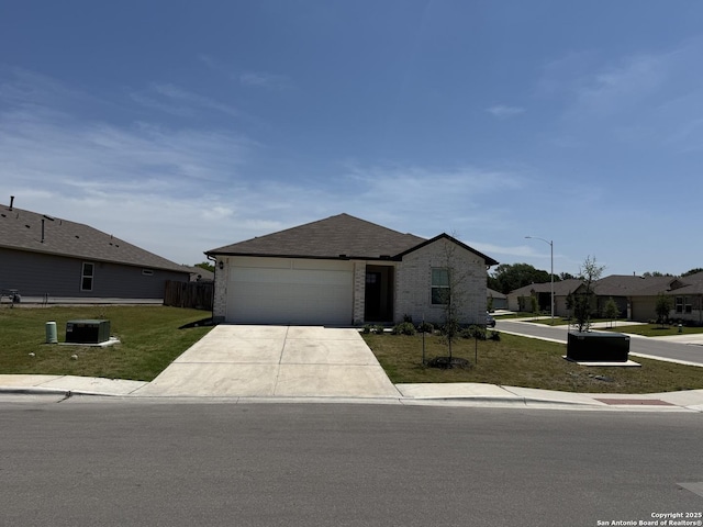 322 Addison, Lockhart, TX 78644 - view of front facade featuring driveway, brick siding, an attached garage, and central AC