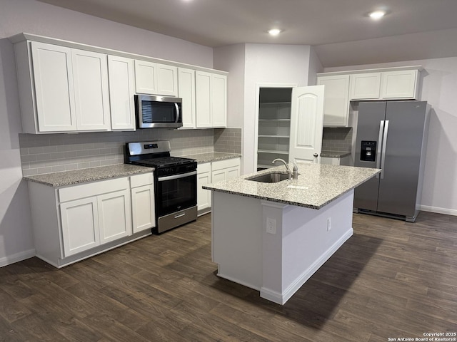 322 Addison, Lockhart, TX 78644 - kitchen featuring appliances with stainless steel finishes, a sink, tasteful backsplash, white cabinets, and light stone counters