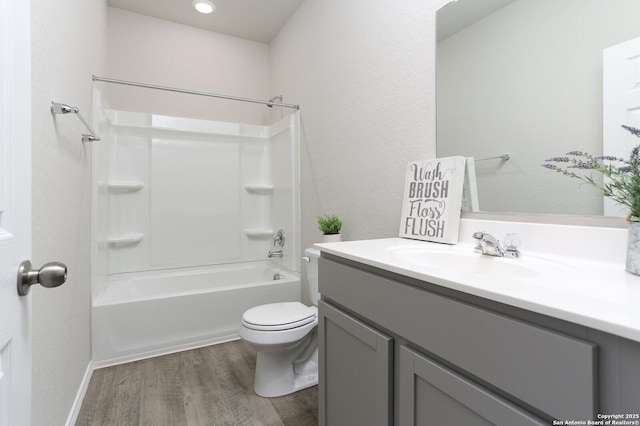 14647 Stirrup Trce, Elmendorf, TX 78112 - bathroom with wood finished floors, toilet, vanity, and  shower combination