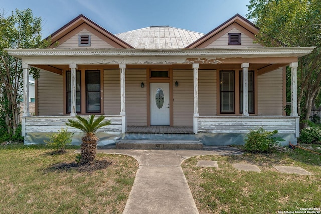 227 College, Seguin, TX 78155 - view of front facade featuring a porch, metal roof, and a standing seam roof