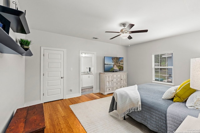 419 Channing Ave, San Antonio, TX 78210 - bedroom featuring light wood-type flooring, connected bathroom, and ceiling fan
