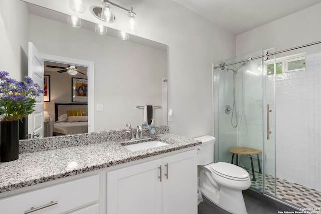 419 Channing Ave, San Antonio, TX 78210 - bathroom with a shower stall, toilet, connected bathroom, a ceiling fan, and vanity
