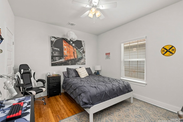 419 Channing Ave, San Antonio, TX 78210 - bedroom featuring baseboards, wood finished floors, and a ceiling fan