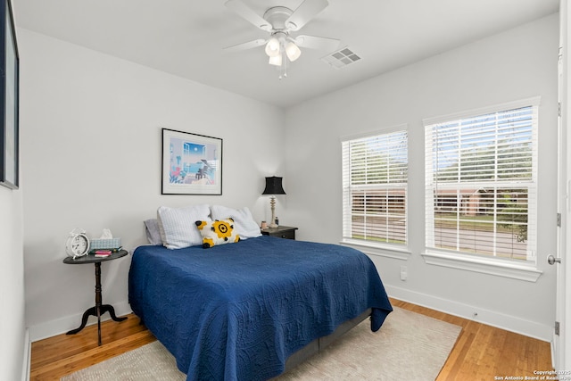 419 Channing Ave, San Antonio, TX 78210 - bedroom featuring baseboards, wood finished floors, and a ceiling fan