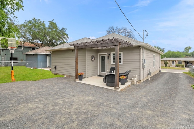 419 Channing Ave, San Antonio, TX 78210 - view of front of home with a pergola, a patio area, and a shingled roof
