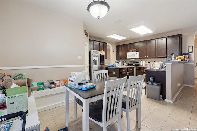 404 Eagle Flight, Cibolo, TX 78108 - dining area featuring light tile patterned floors and arched walkways