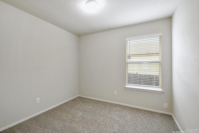 10374 Oakwood Crst, San Antonio, TX 78245 - unfurnished room with carpet flooring, baseboards, and a textured ceiling