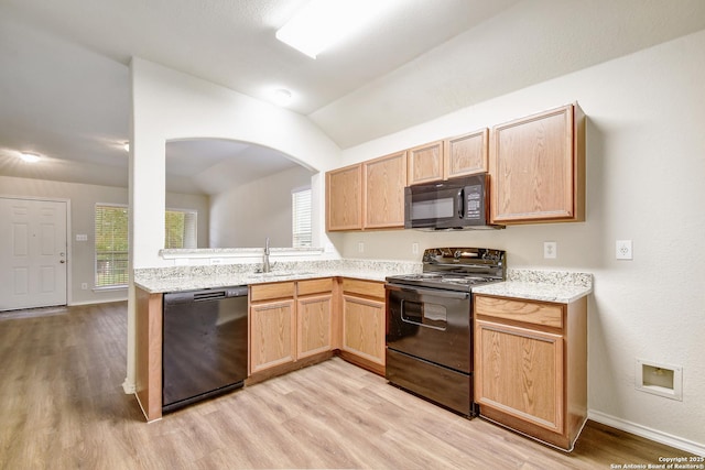 10374 Oakwood Crst, San Antonio, TX 78245 - kitchen featuring black appliances, a sink, light wood-style floors, light brown cabinetry, and lofted ceiling