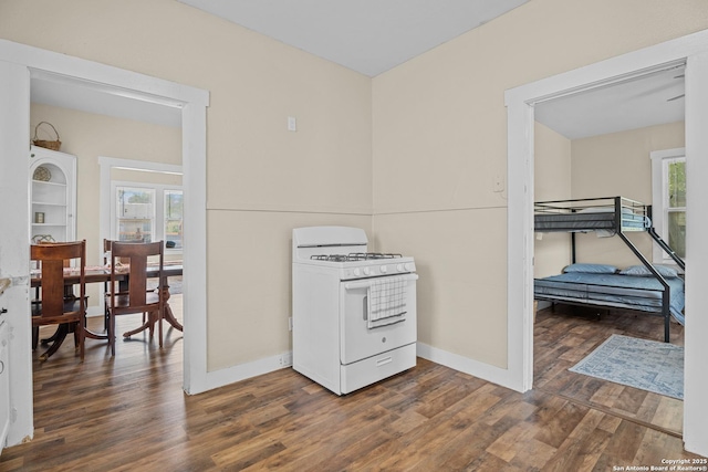 1726 Center, San Antonio, TX 78202 - kitchen with white gas range, healthy amount of natural light, dark wood-type flooring, and baseboards