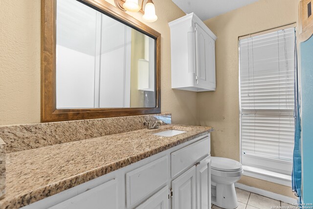120 Westridge Dr, Springtown, TX 76082 - bathroom featuring toilet, tile patterned flooring, vanity, and a textured wall