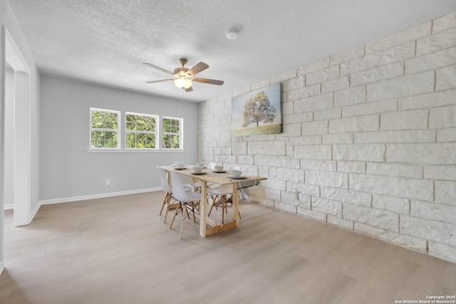 97 Denton, San Antonio, TX 78213 - dining room featuring wood finished floors, a ceiling fan, a textured ceiling, and baseboards