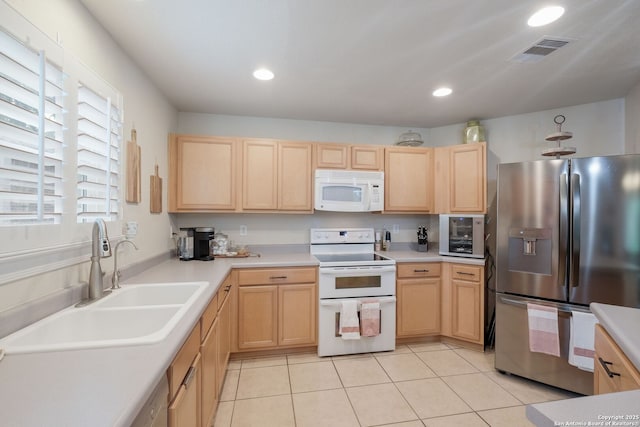 8022 Maddie Ln, San Antonio, TX 78255 - kitchen featuring white appliances, light brown cabinetry, and recessed lighting