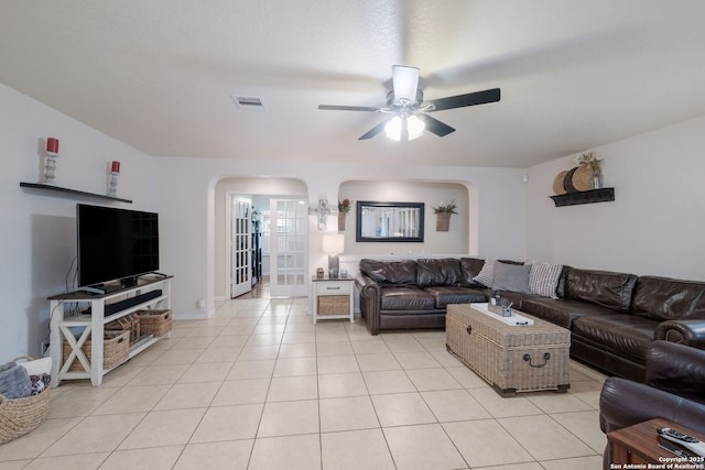 8022 Maddie Ln, San Antonio, TX 78255 - living area featuring arched walkways, light tile patterned flooring, a ceiling fan, and french doors