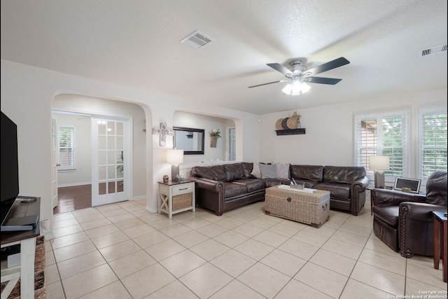 8022 Maddie Ln, San Antonio, TX 78255 - living area with arched walkways, a ceiling fan, and light tile patterned floors
