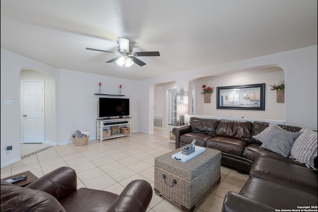 8022 Maddie Ln, San Antonio, TX 78255 - living area featuring arched walkways, light tile patterned floors, ceiling fan, and baseboards