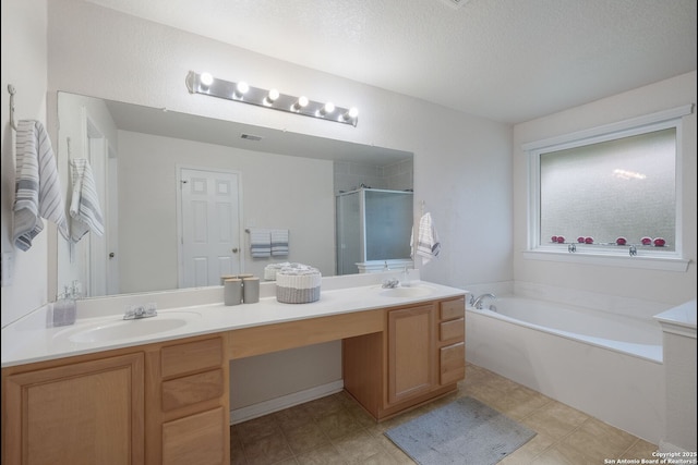 8022 Maddie Ln, San Antonio, TX 78255 - bathroom with double vanity, a garden tub, a shower stall, and a textured ceiling