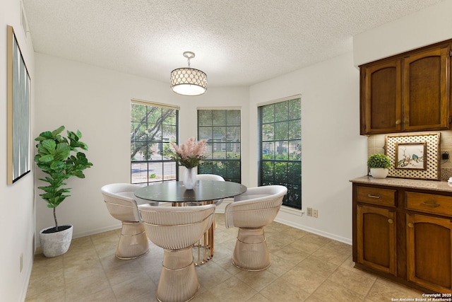 7519 Dijon Ct, San Antonio, TX 78209 - dining room with a textured ceiling, baseboards, and light tile patterned floors