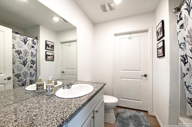 923 Cook Bnd, San Antonio, TX 78221 - bathroom featuring vanity, toilet, wood finished floors, and curtained shower