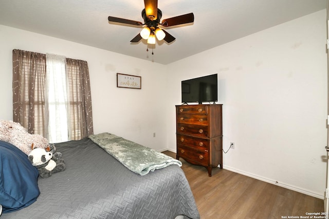 923 Cook Bnd, San Antonio, TX 78221 - bedroom featuring wood finished floors, baseboards, and a ceiling fan