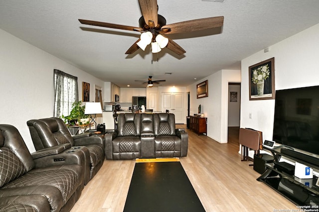 923 Cook Bnd, San Antonio, TX 78221 - living area with a ceiling fan, light wood-style floors, and baseboards