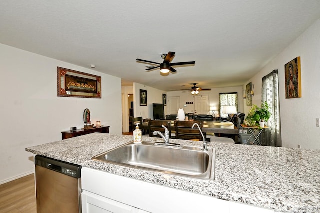 923 Cook Bnd, San Antonio, TX 78221 - kitchen featuring dishwasher, a sink, a ceiling fan, light wood-type flooring, and white cabinets