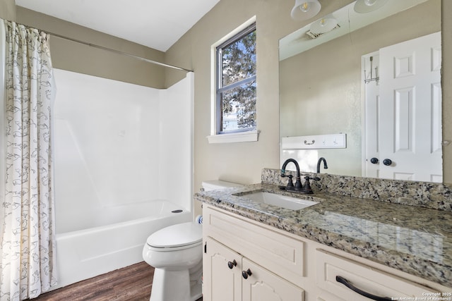 210 Daffodil St, Lake Jackson, TX 77566 - bathroom featuring wood finished floors, shower / tub combo, vanity, and toilet