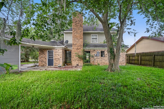 210 Daffodil St, Lake Jackson, TX 77566 - back of property with a chimney and brick siding