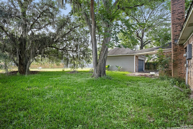 210 Daffodil St, Lake Jackson, TX 77566 - view of yard with an attached garage