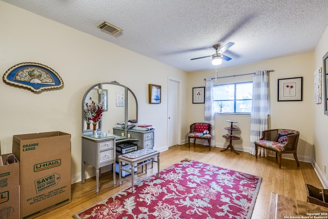 9618 Alderwood, San Antonio, TX 78250 - living area with ceiling fan, light wood-style floors, a textured ceiling, and baseboards