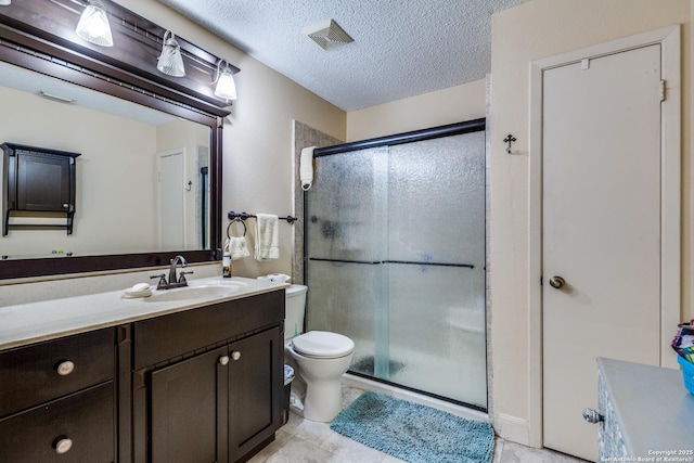 9618 Alderwood, San Antonio, TX 78250 - full bath featuring a stall shower, vanity, toilet, a textured ceiling, and tile patterned flooring