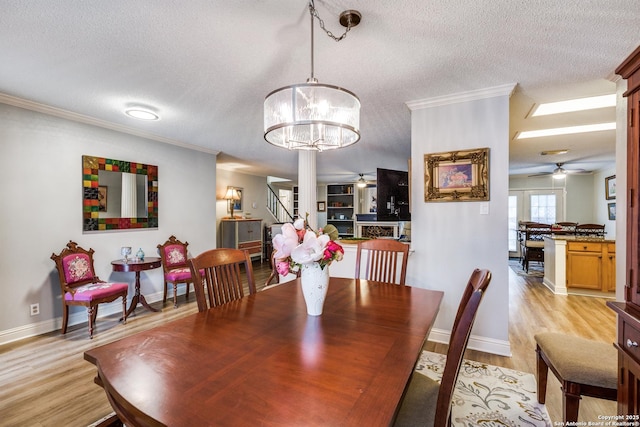 9618 Alderwood, San Antonio, TX 78250 - dining space with ceiling fan, light wood-style flooring, crown molding, a textured ceiling, and baseboards