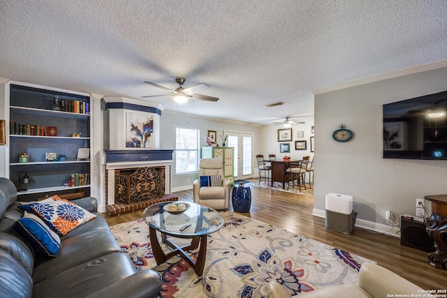 9618 Alderwood, San Antonio, TX 78250 - living area with ceiling fan, ornamental molding, wood finished floors, baseboards, and a textured ceiling